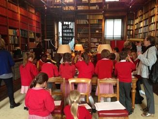 A picture showing school children during a session in the RAS library