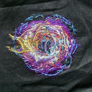 The remains of a supernova explosion created using embroidery.