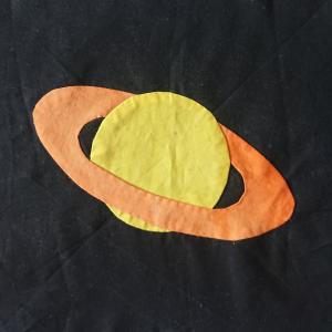 A yellow circle with orange rings around it on a black background.