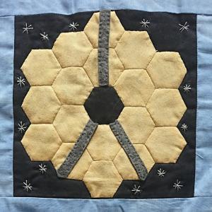 The James Webb Space Telescope created with patchwork fabric.