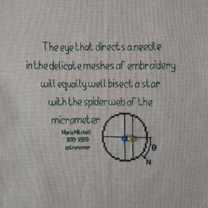 Black embroidered quote on a white background. The text reads: "The eye that directs a needle in the delicate meshes of embroidery will equally well bisect a star with the spiderweb pf the micrometre. Maria Mitchell, astronomer 1818-1889"