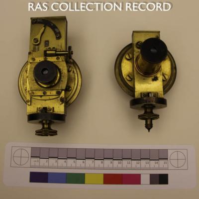 Two vertically positioned brass filar micrometers