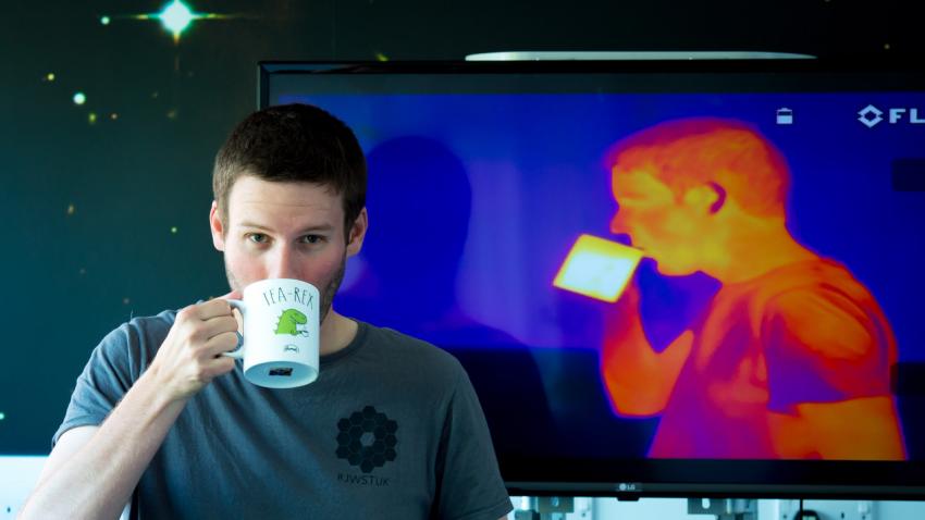 An infra-red camera captures a man with a cup of tea as white hot.