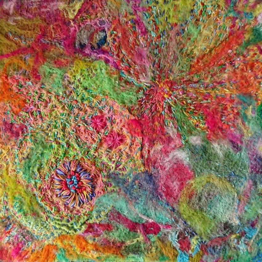 Artist's impression of a galaxy using colourful stitches and felting.