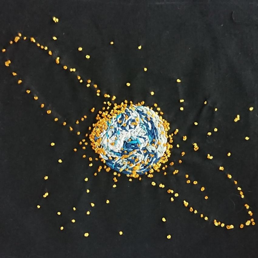 All the satellites in a geostationary or other orbits surrounding the Earth, created in blue, white and yellow threads on a black background.