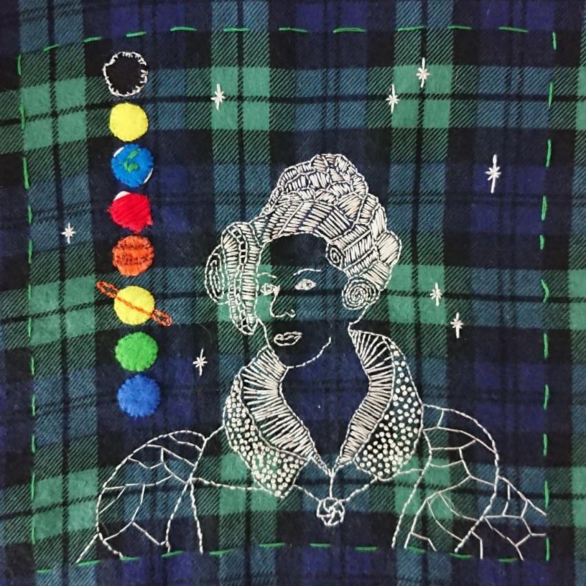 Mary Somerville, plus the eight major planets embroidered on a tartan background.