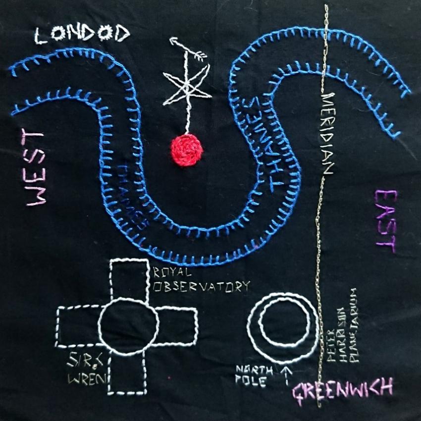 A basic map showing the prime meridian, Greenwich Observatory and the river Thames embroidered in white and blue threads on a black background.