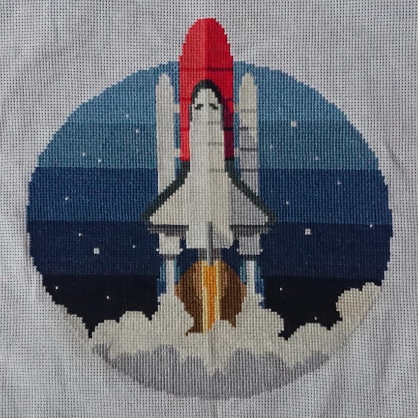 Cross stitch of the space shuttle Discovery at launch.