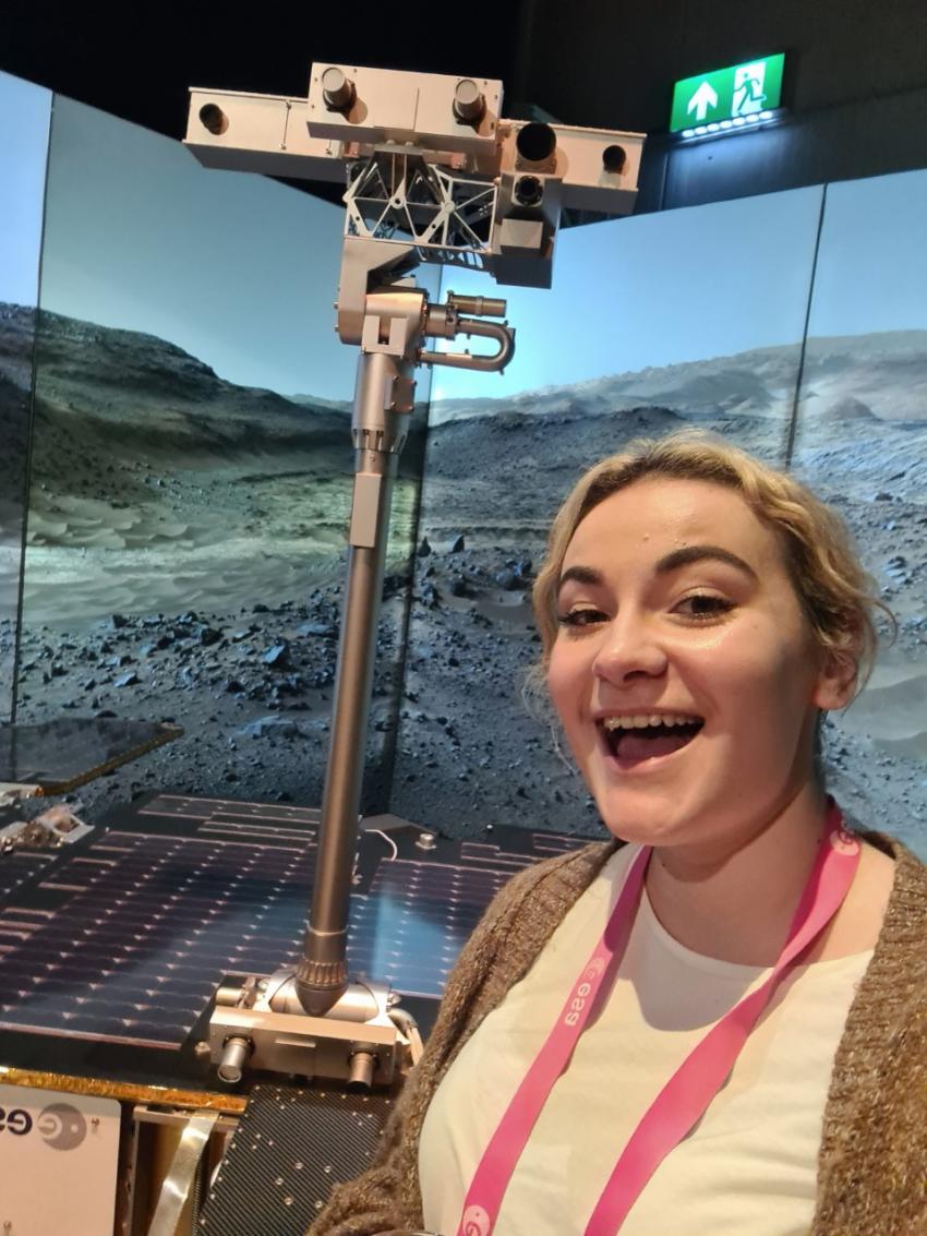 Speaker Catherine Regan standing next to a model of the ExoMars rover