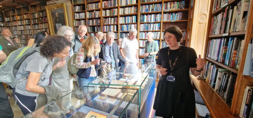 The Royal Astronomical Society's archivist and librarian Sian Prosser speaks to visitors in the library.