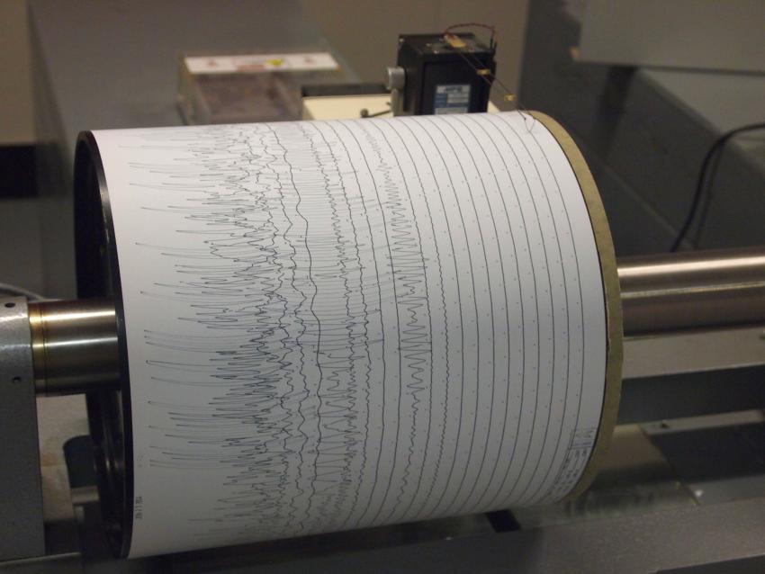 A seismograph detecting the ground shaking.