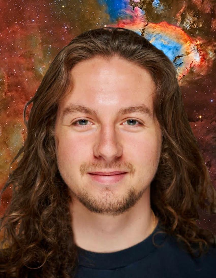 Front-facing Phd student with long brown hair and a backdrop of the Fish Head nebula.