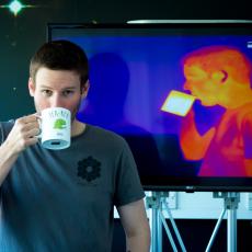 An infra-red camera captures a man sipping tea that is white hot.