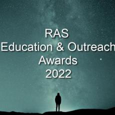 Sillhouette of a person standing against a starry night sky.