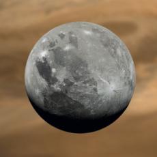 Grey icy moon Ganymede in front of orange Jupiter