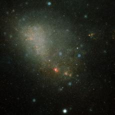 Image of the Magellanic Cloud, a faint loosely bound galaxy in light blue colours.