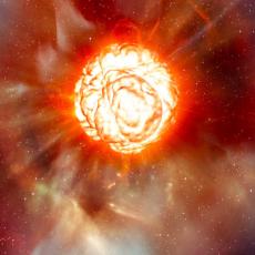 a large orange star is seen exploding, with layers of orange fiery looking material being blown outwards as well as rays of high energy.