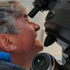 Patrick Poitevin looking through a telescope eyepiece