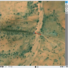 Satellite image showing a wadi crossing a road within part of the Zooniverse interface that allows the pictures to be marked.