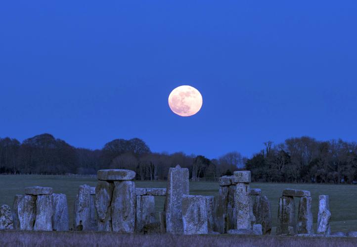 The Moon is pictured above Stonehenge.
