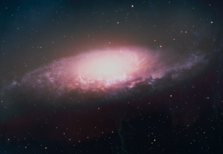 An artist’s impression of a bright quasar almost outshining its host galaxy.