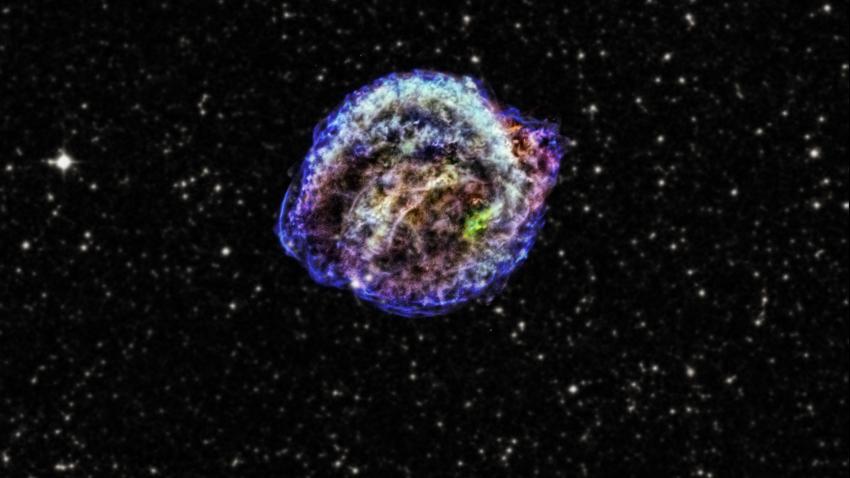 Image of a supernova remnant, with different areas of gas and dust highlighted in different colours