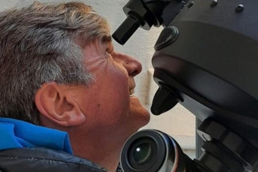 Patrick Poitevin looking through a telescope eyepiece