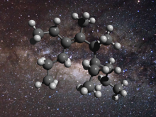 An illustration of the structure of a greasy carbon molecule, set against an image of the galactic centre, where this material has been detected.
