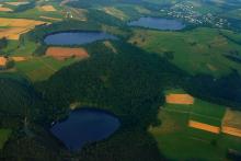 Aerial photograph of three water-filled maars in the Eifel, Germany
