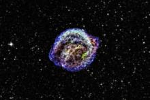 Image of a supernova remnant, with different areas of gas and dust highlighted in different colours